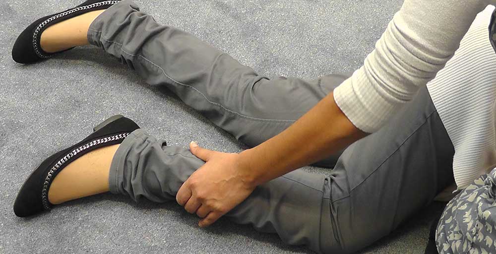 Move the bent leg that is nearest to you, in front of their body so that it is resting on the floor. This position will help to balance them.